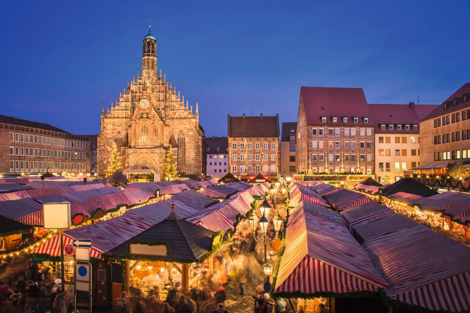 Christmas market with a church at dusk in Nuremberg