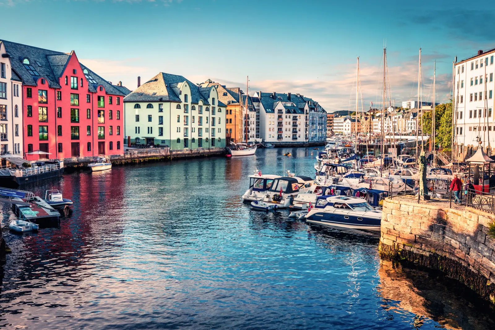 Colourful buildings and boats on a coast beneath a clear sky.