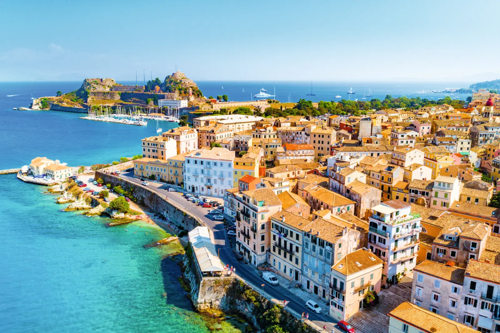Aerial view of a coastal town with historic buildings by the sea.