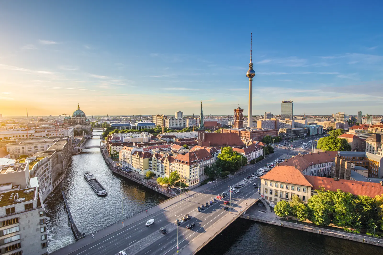 Berlin cityscape with the television tower and river at sunset.