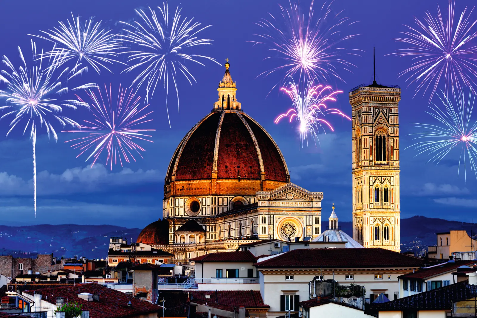La cattedrale di Firenze di notte con i fuochi d'artificio sullo sfondo.