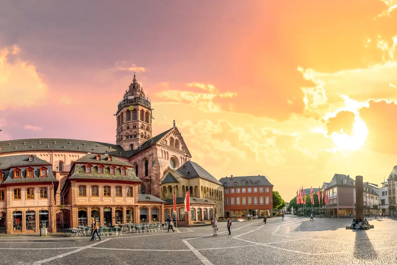 Main square with historic buildings and cathedral at sunset in Mainz.