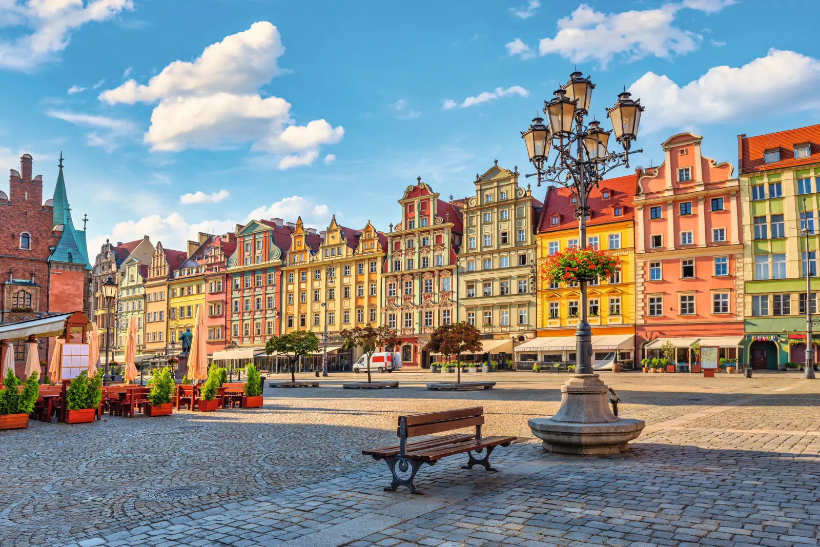Colourful historic buildings on the market square in Wrocław on a sunny day with blue skies.