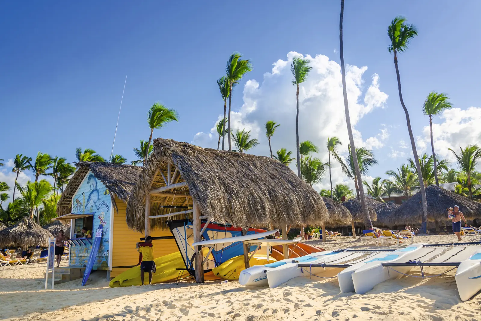 Kayaks, sailing boats and catamarans on a beach in the Bahamas in the Caribbean archipelago.