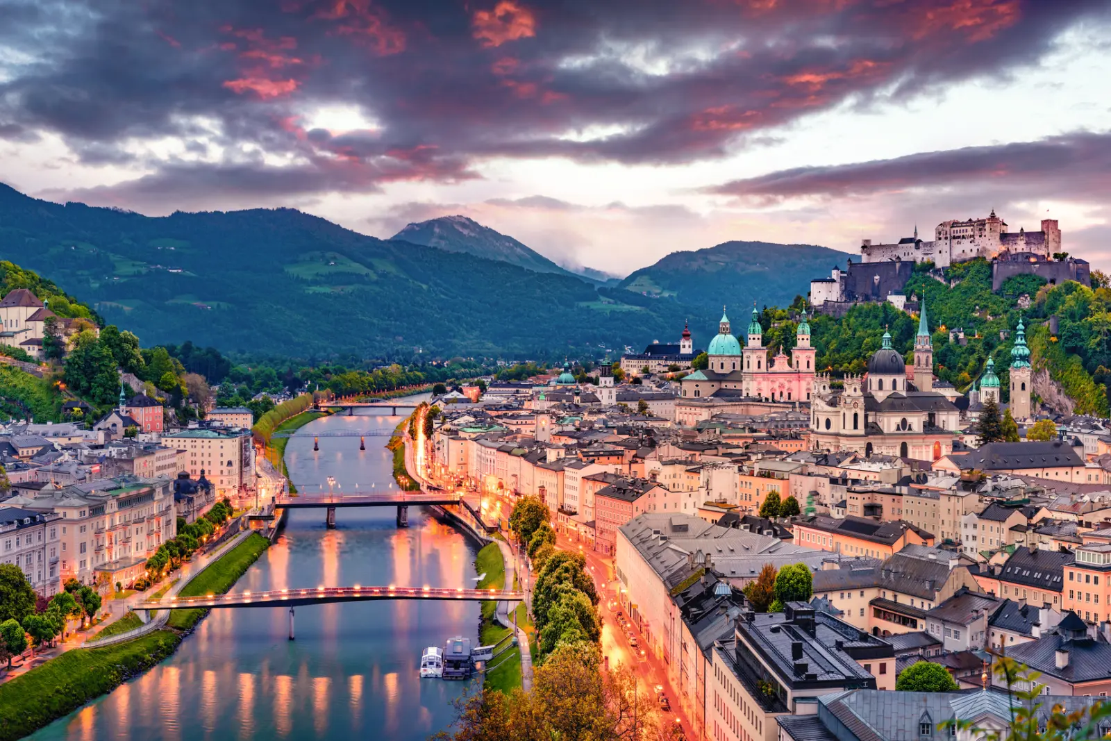 View of Salzburg with the fortress in the background at sunset.