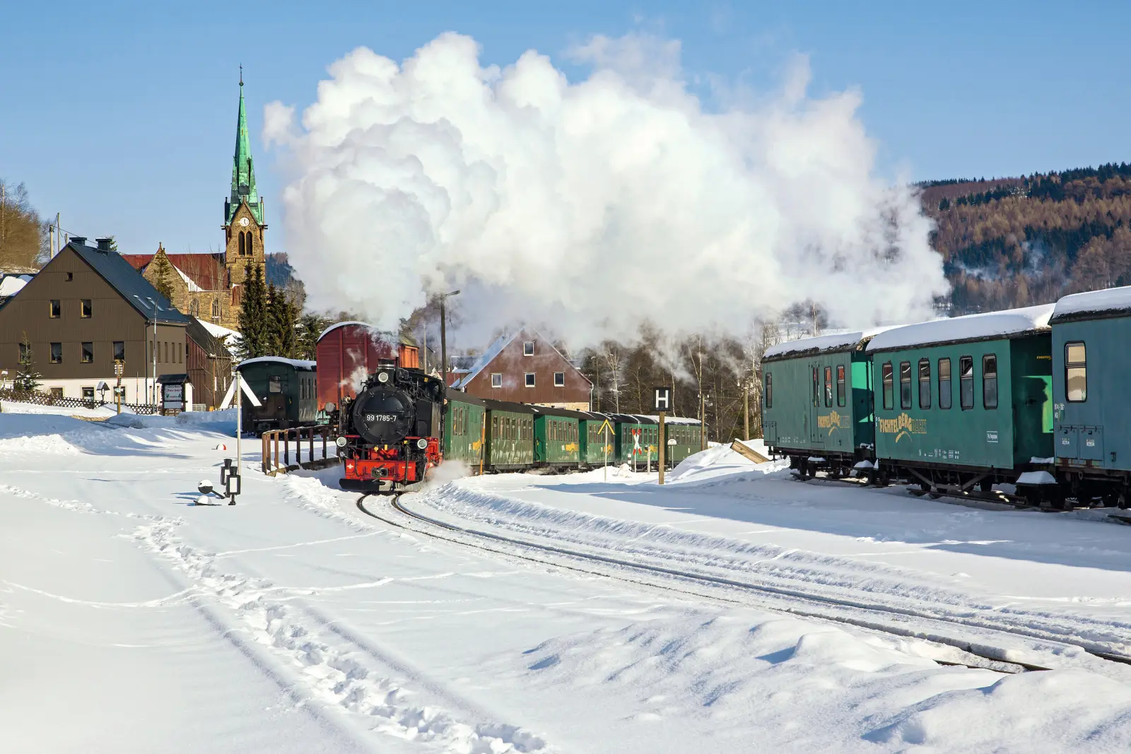 Steam locomotive of the Fichtelberg Railway at the snow-covered station of Hammerunterwiesenthal.