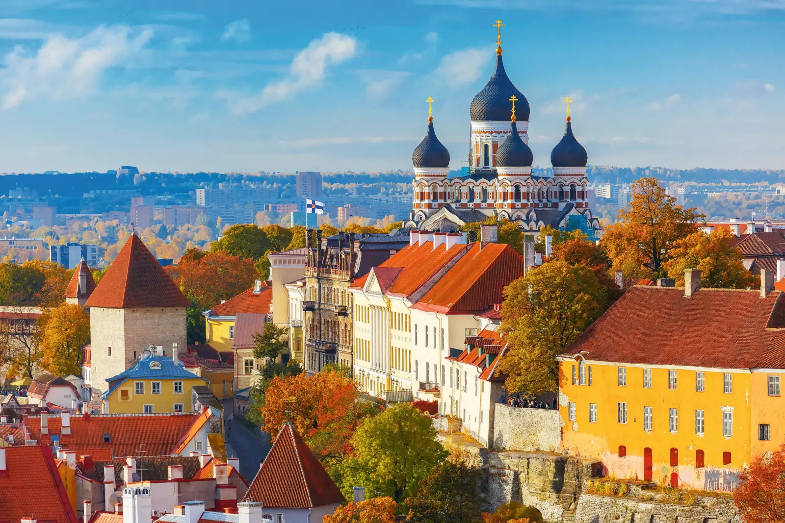 City view with a Russian Orthodox cathedral in autumn, blue sky in the background.