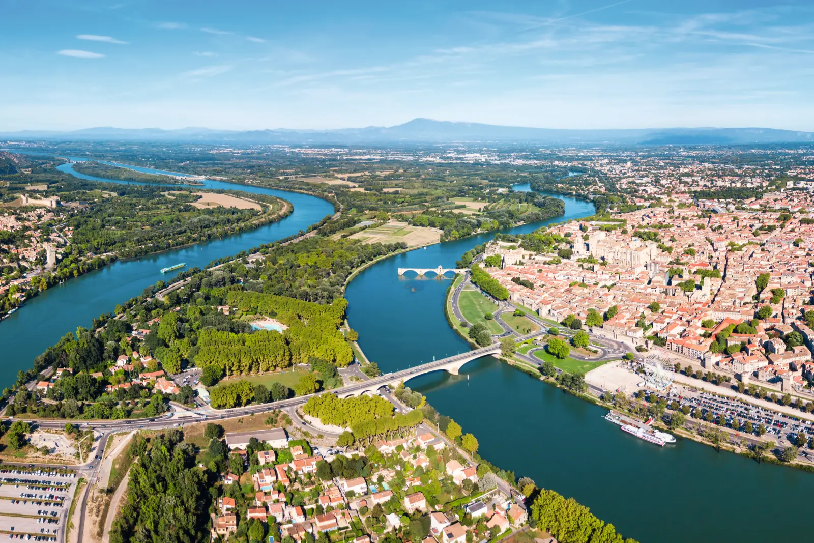 Aerial view of a river with bridges and a cityscape in the background.