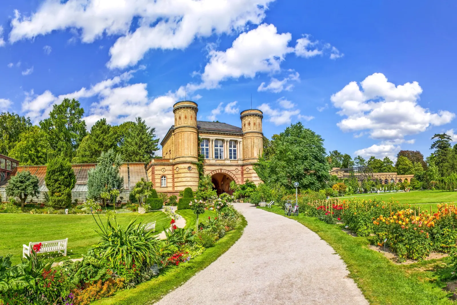 Palace with landscaped gardens and a blue sky in the background.