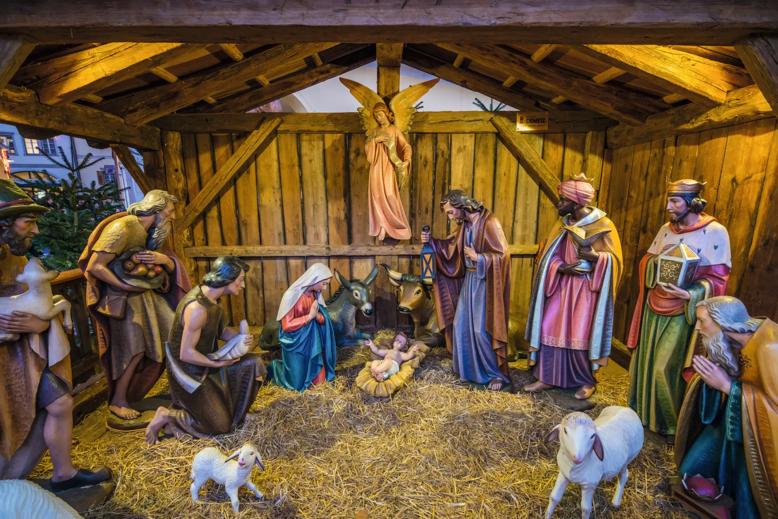 Nativity scene with wooden figures of Mary, Joseph and the Christ Child in the centre.
