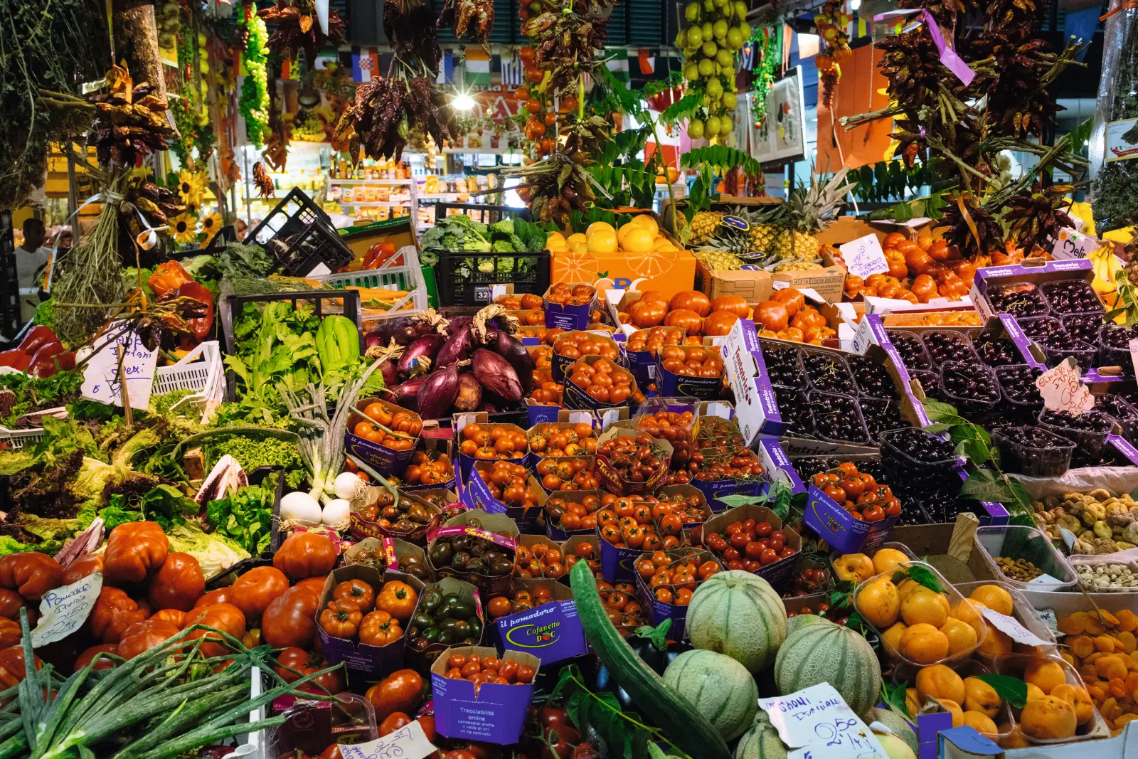 Market stall with fresh fruit and vegetables in vibrant colours.