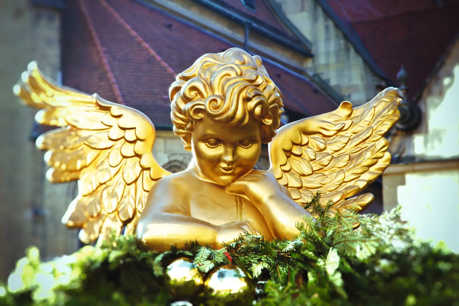 Christmas angel at the Stuttgart Christmas market surrounded by festive decorations.
