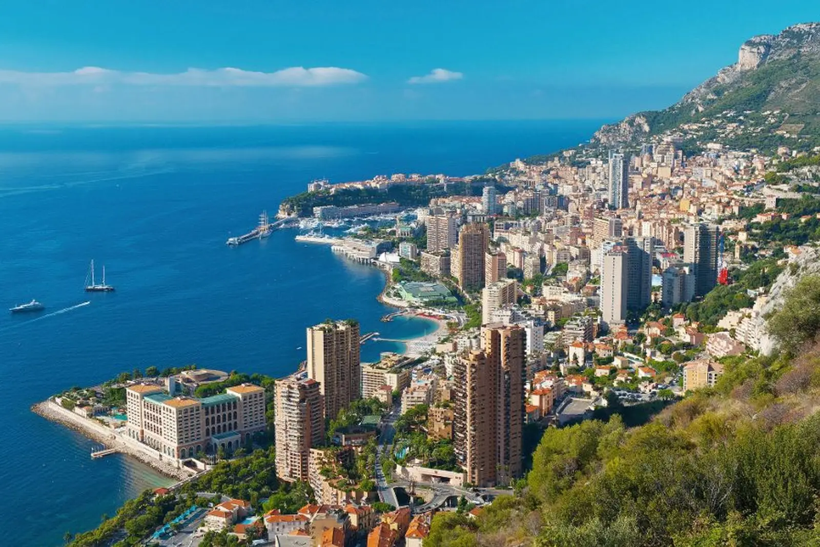 Monaco coastline with high-rise buildings and blue sea in the background.