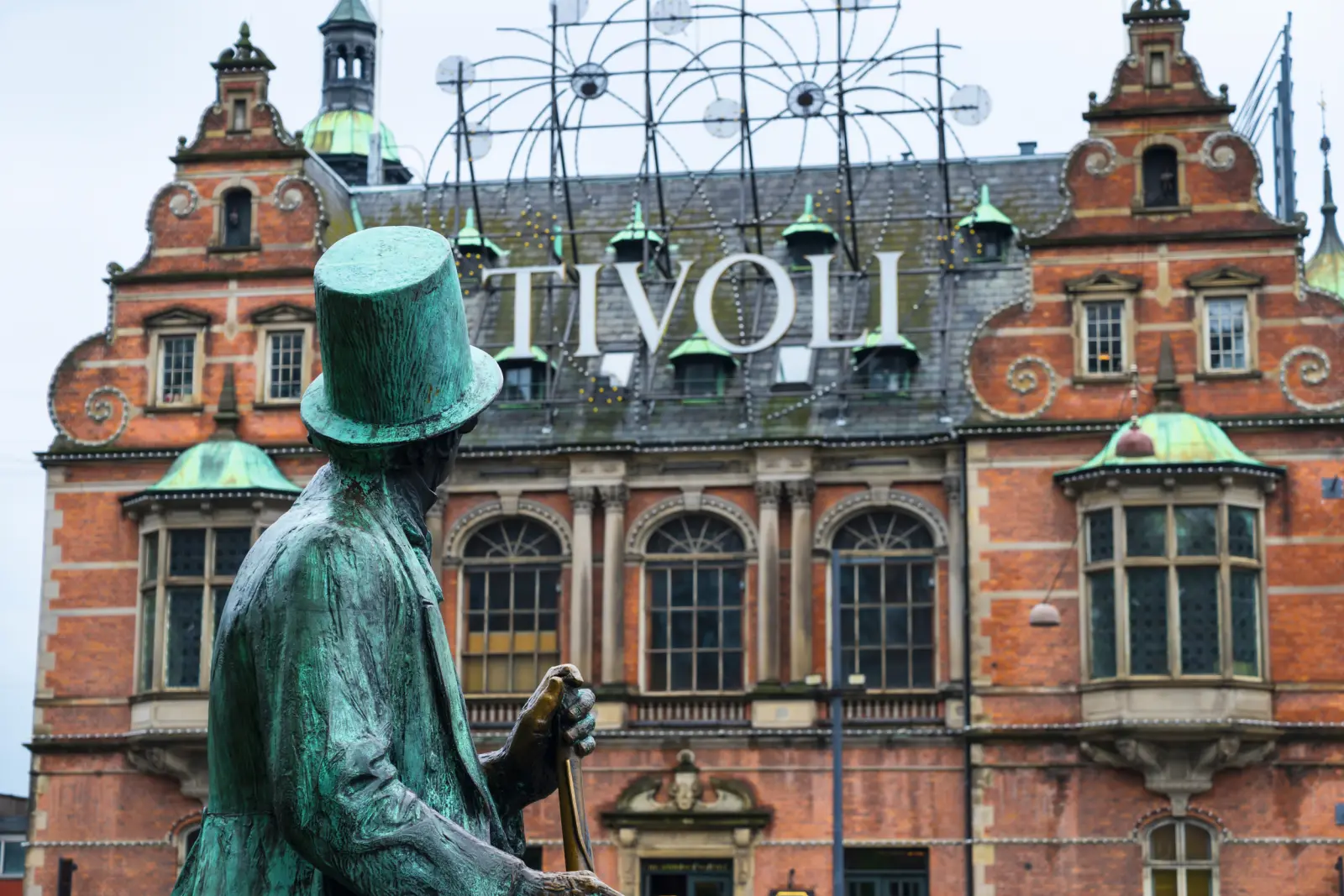 Bronze statue in front of the historic Tivoli building in Copenhagen.