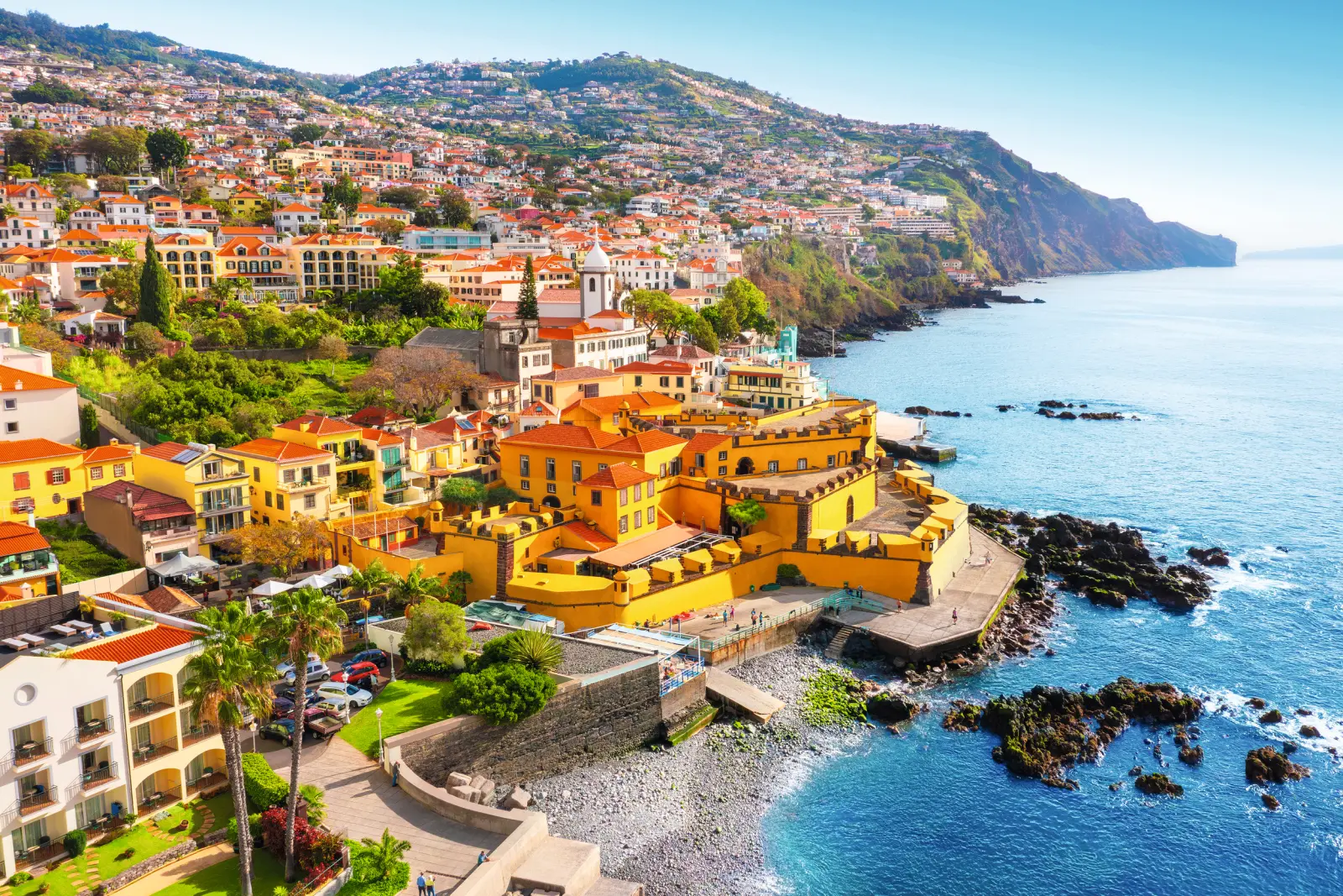 Coastal town with colourful buildings and sea views.