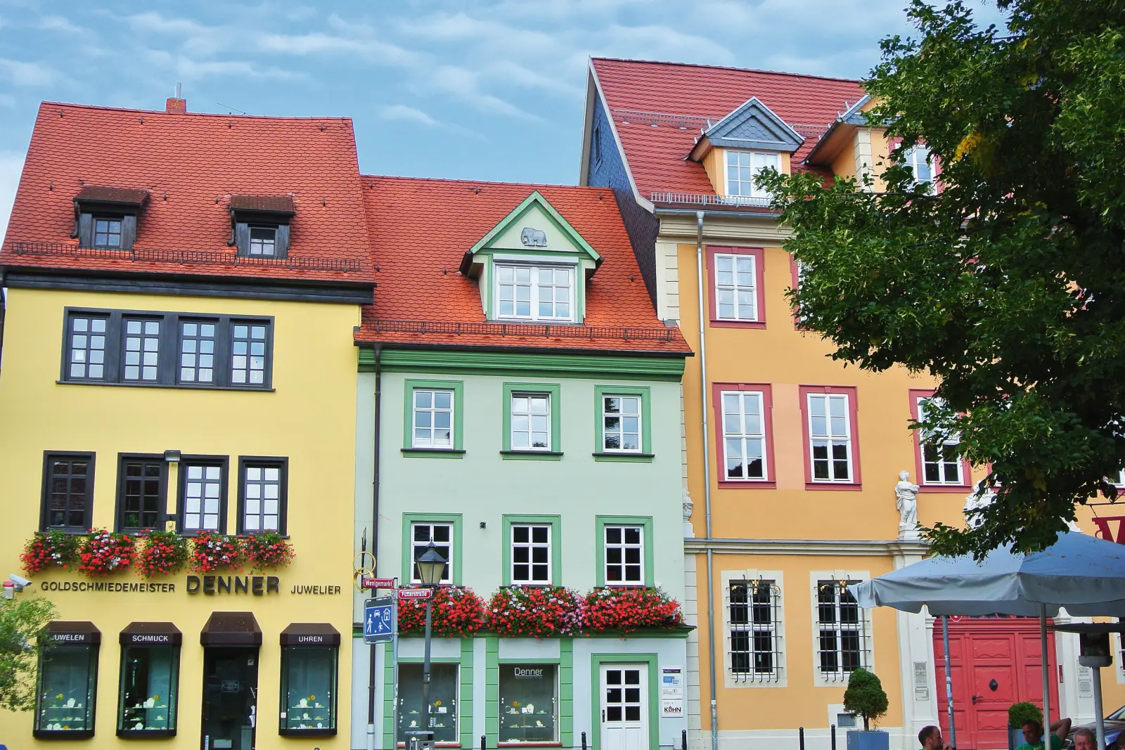 Colourful historic house façades in Erfurt, blue sky in the background.