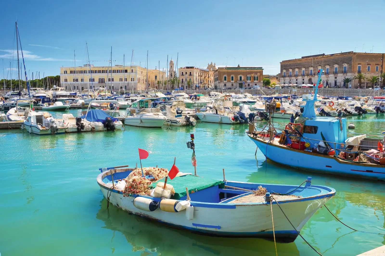 Boat in the harbour with other boats in the background in sunny weather.