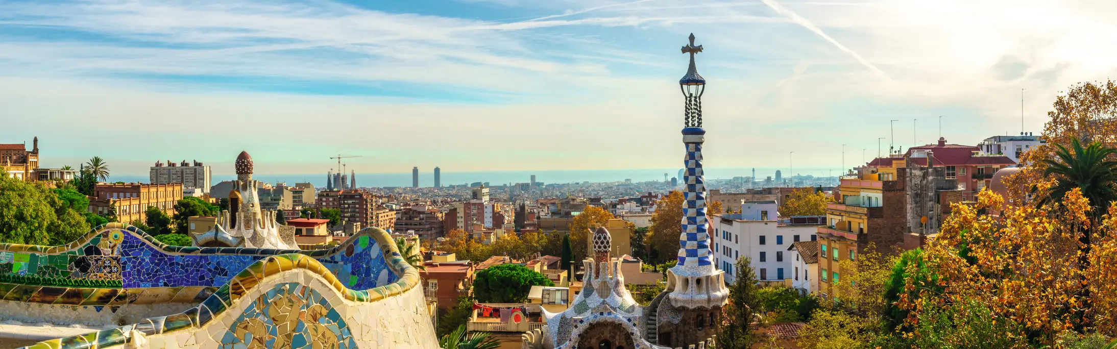 Park Güell in Barcelona with a view of the city in the background on a sunny day.