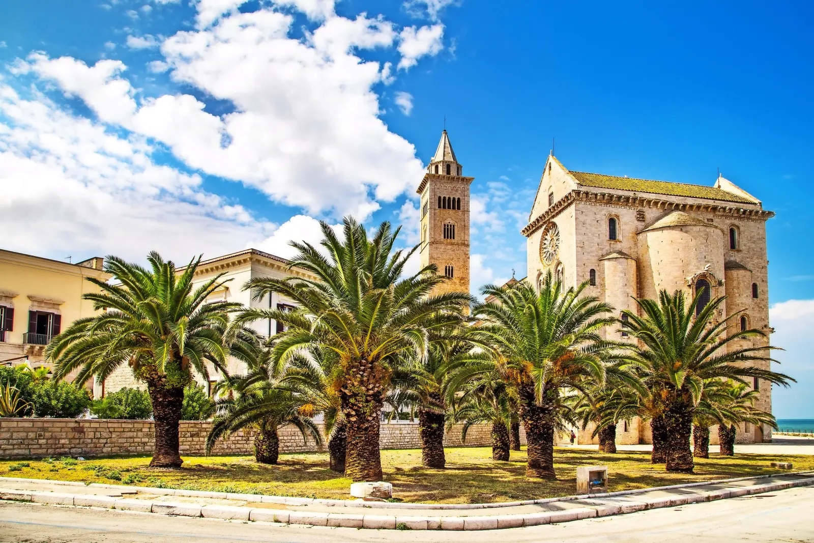 Church with palm trees and blue sky in the background.