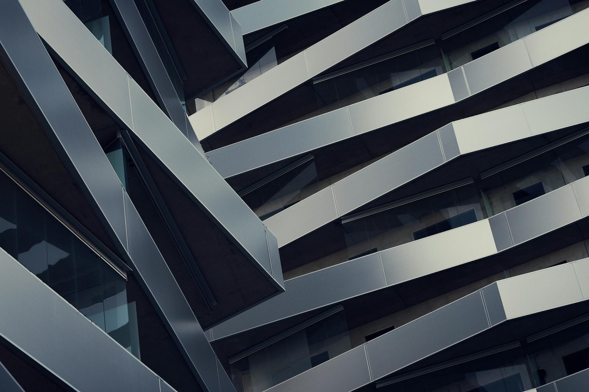 A close-up view of a modern building with a unique architectural design featuring staggered balconies.